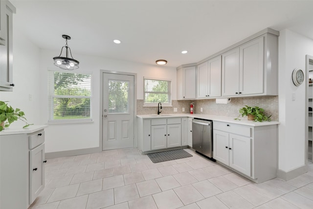 10166 San Lorenzo Dr, Dallas, TX 75228 - kitchen with stainless steel dishwasher, a sink, backsplash, light countertops, and baseboards