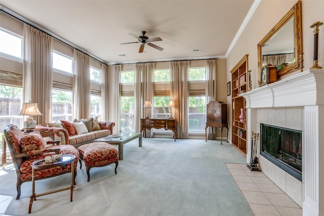 3671 Navarro Way, Frisco, TX 75034 - living room featuring ceiling fan, crown molding, plenty of natural light, light colored carpet, and a tiled fireplace