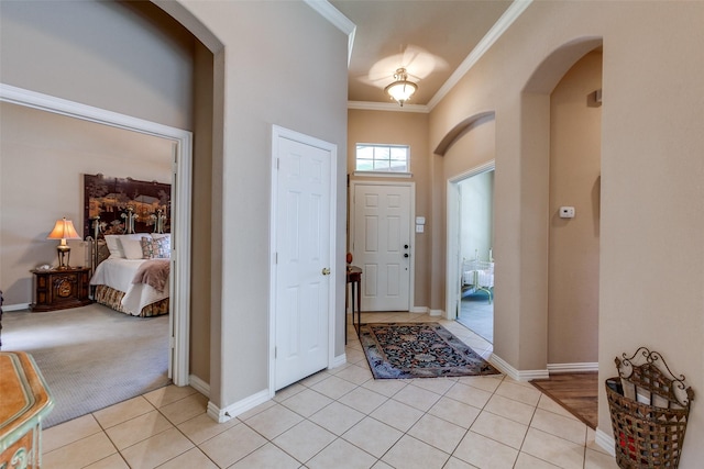 3671 Navarro Way, Frisco, TX 75034 - entrance foyer with arched walkways, ornamental molding, light tile patterned flooring, baseboards, and light colored carpet