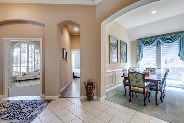 3671 Navarro Way, Frisco, TX 75034 - dining area with arched walkways, light tile patterned flooring, and ornamental molding
