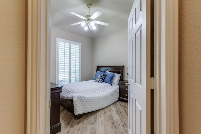 3671 Navarro Way, Frisco, TX 75034 - bedroom with light wood-type flooring, ceiling fan, and a textured wall