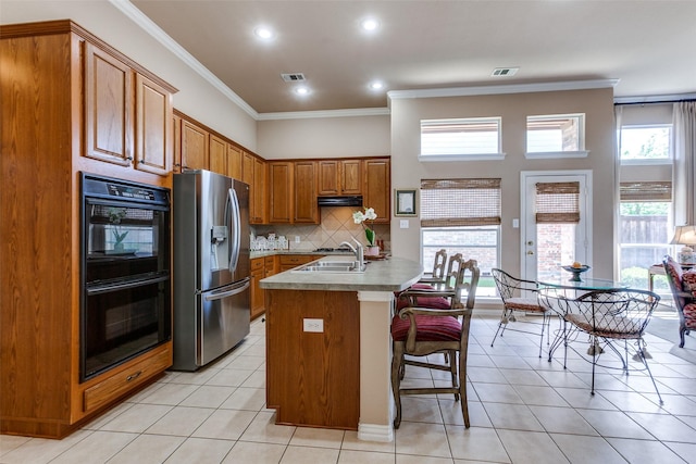 3671 Navarro Way, Frisco, TX 75034 - kitchen featuring stainless steel refrigerator with ice dispenser, brown cabinetry, light tile patterned flooring, ornamental molding, and tasteful backsplash