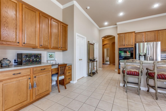 3671 Navarro Way, Frisco, TX 75034 - kitchen with stainless steel fridge with ice dispenser, arched walkways, crown molding, light tile patterned flooring, and recessed lighting