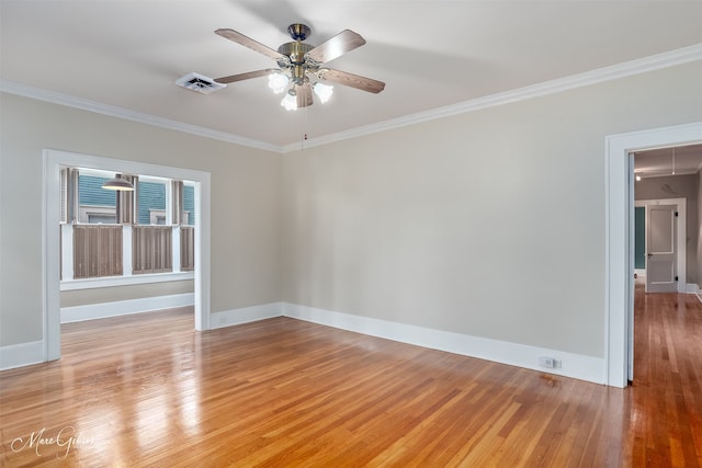 unfurnished room with ornamental molding, ceiling fan, light wood finished floors, and baseboards