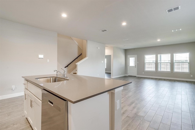 600 Trinity Park Trl, Alvarado, TX 76009 - kitchen featuring stainless steel dishwasher, a sink, baseboards, light wood finished floors, and an island with sink