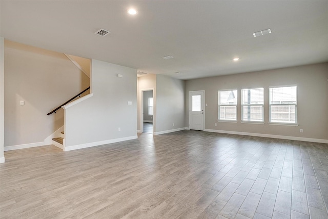 600 Trinity Park Trl, Alvarado, TX 76009 - unfurnished living room featuring baseboards, wood finished floors, stairs, and recessed lighting