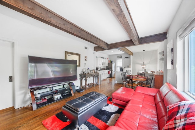 living room with dark wood-style flooring and beam ceiling