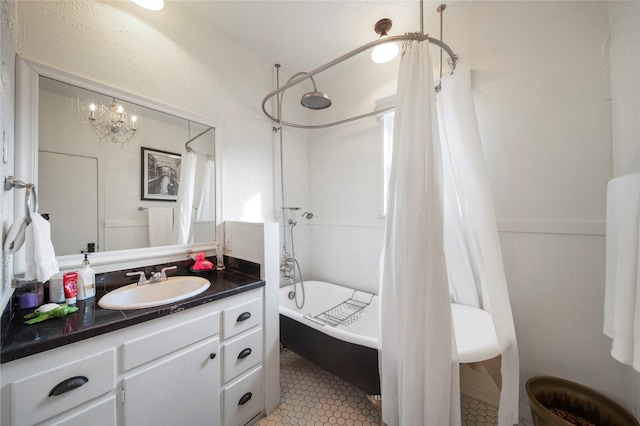 full bath featuring shower / bathtub combination with curtain, a wainscoted wall, vanity, and tile patterned flooring