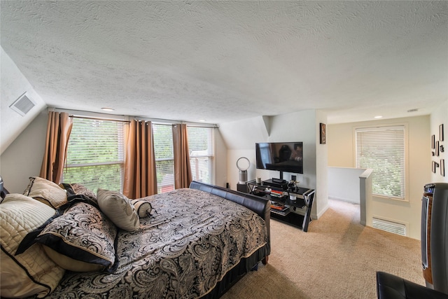 bedroom featuring a textured ceiling, carpet, and lofted ceiling