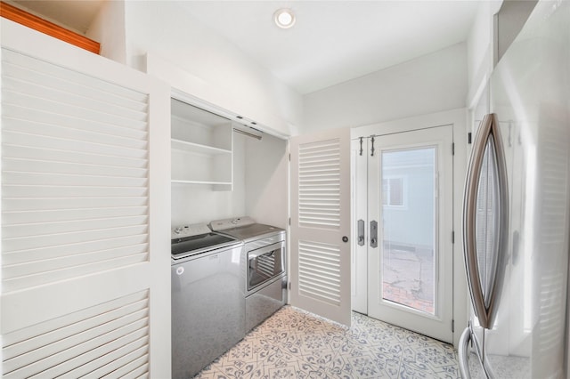 clothes washing area featuring washer and clothes dryer