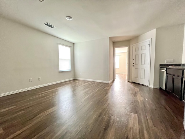710 S 20th St, Temple, TX 76501 - unfurnished living room with dark wood-style floors and baseboards