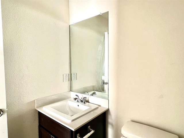 710 S 20th St, Temple, TX 76501 - bathroom with toilet, vanity, and a textured wall