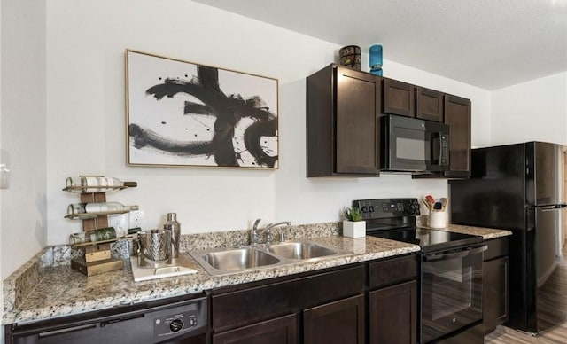 710 S 20th St, Temple, TX 76501 - kitchen featuring black appliances, a sink, dark brown cabinetry, and light stone countertops