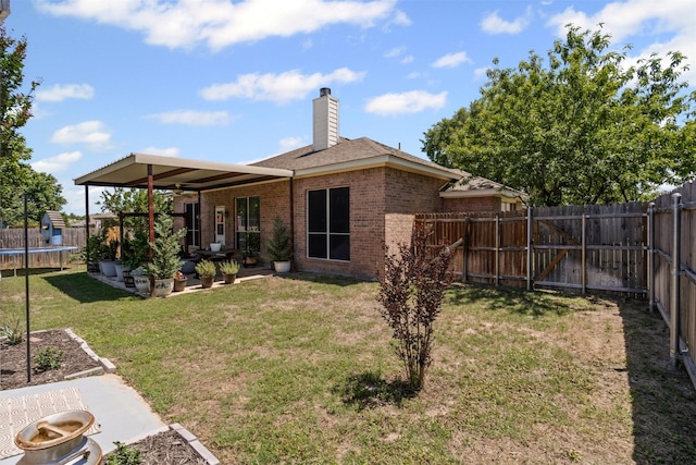 221 Whitestone Way, Weatherford, TX 76085 - back of house with a patio, a trampoline, a fenced backyard, and brick siding