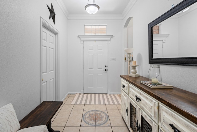 221 Whitestone Way, Weatherford, TX 76085 - foyer featuring arched walkways, light tile patterned floors, ornamental molding, and baseboards