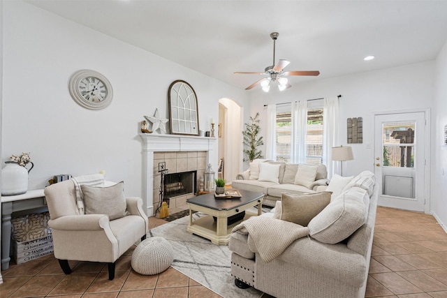 221 Whitestone Way, Weatherford, TX 76085 - living area with tile patterned floors, ceiling fan, a tiled fireplace, recessed lighting, and arched walkways