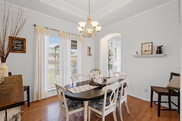 221 Whitestone Way, Weatherford, TX 76085 - dining room with arched walkways, light wood finished floors, a chandelier, crown molding, and baseboards