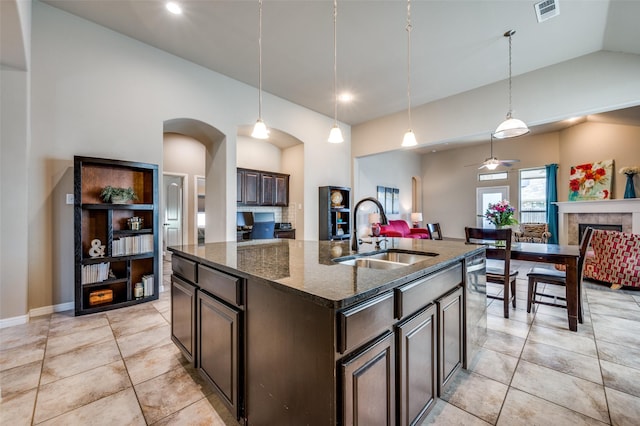 2617 Castle Creek Dr, Little Elm, TX 75068 - kitchen with a sink, open floor plan, vaulted ceiling, dark brown cabinetry, and dishwasher