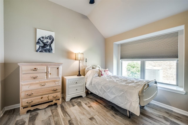 2617 Castle Creek Dr, Little Elm, TX 75068 - bedroom with lofted ceiling, light wood finished floors, and baseboards