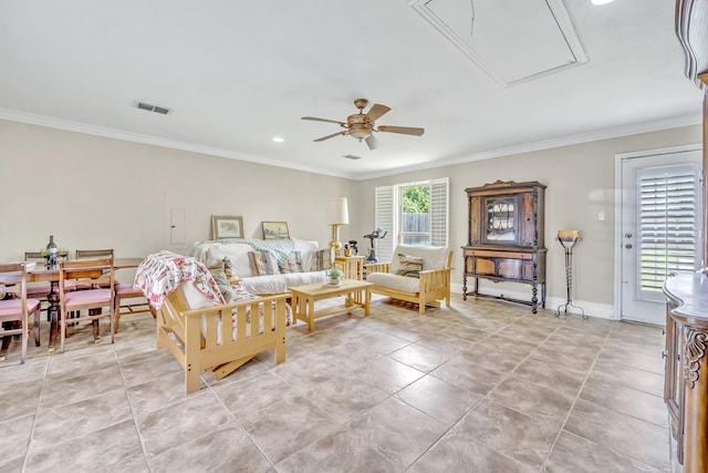 living area with attic access, ceiling fan, ornamental molding, light tile patterned flooring, and recessed lighting