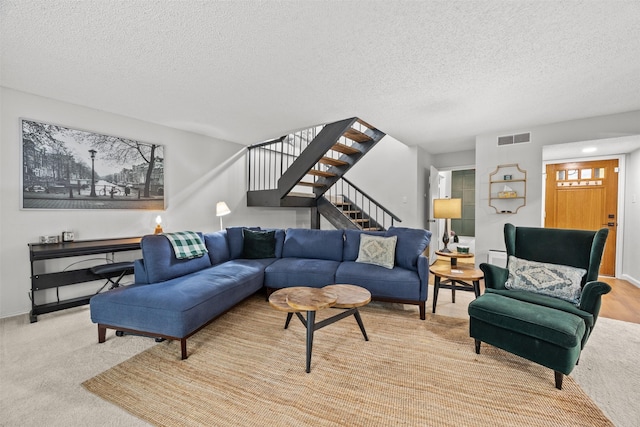 10607 Hillpoint Dr, Dallas, TX 75238 - living area with a textured ceiling, stairway, and carpet floors