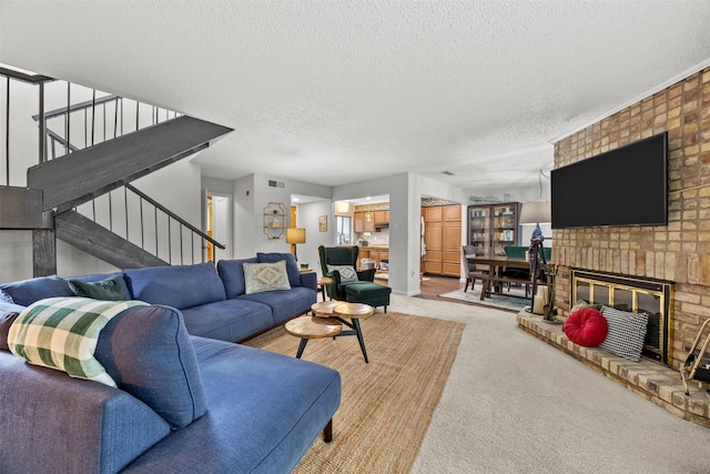 10607 Hillpoint Dr, Dallas, TX 75238 - living area with stairway, carpet floors, a textured ceiling, and a brick fireplace