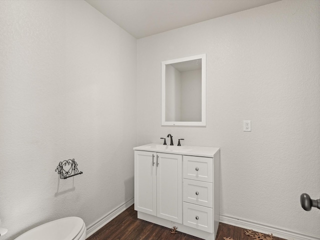 402 Brookview Dr, Decatur, TX 76234 - bathroom with wood finished floors, vanity, toilet, and baseboards