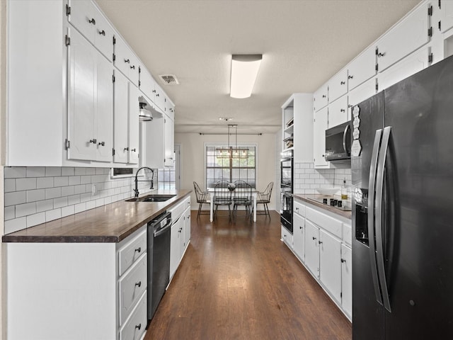 402 Brookview Dr, Decatur, TX 76234 - kitchen featuring refrigerator with ice dispenser, a sink, dishwasher, dark countertops, and white cabinets