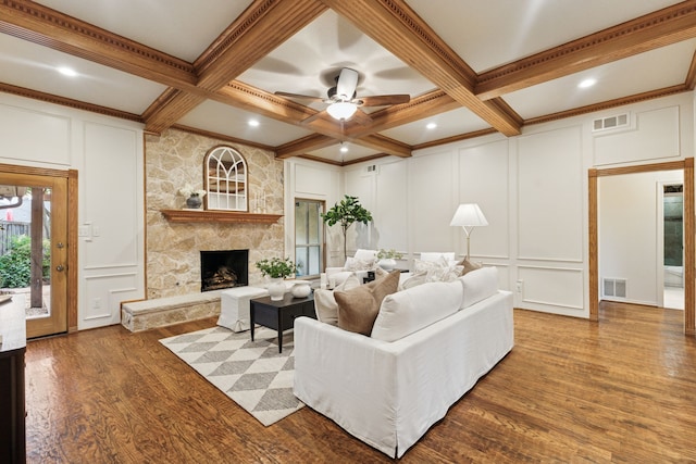1141 Yorkshire Dr, Carrollton, TX 75007 - living area featuring a decorative wall, beamed ceiling, wood finished floors, coffered ceiling, and a fireplace