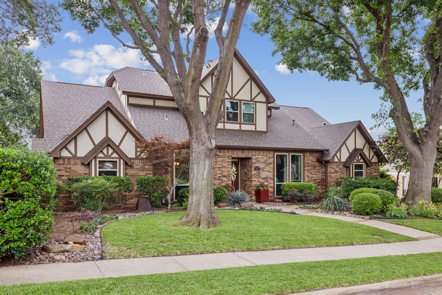 1141 Yorkshire Dr, Carrollton, TX 75007 - tudor-style house with stucco siding, brick siding, and a front lawn