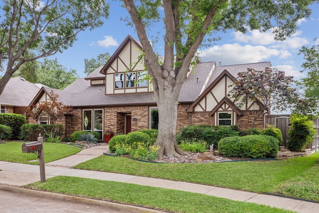 1141 Yorkshire Dr, Carrollton, TX 75007 - tudor-style house with stucco siding, roof with shingles, and brick siding
