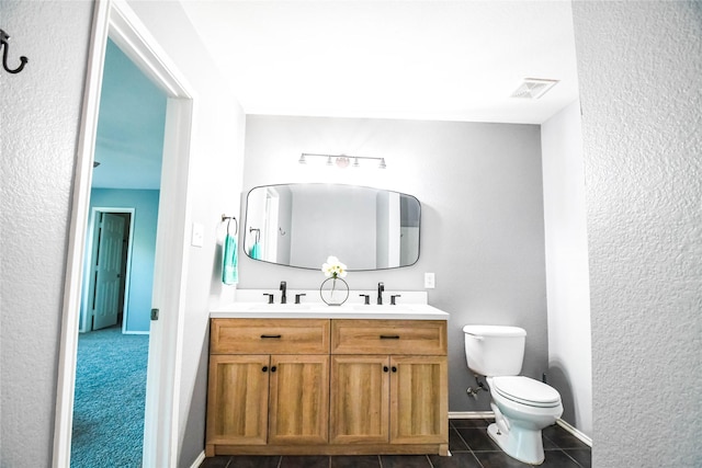 1433 Sun Breeze Dr, Little Elm, TX 75068 - bathroom with toilet, double vanity, tile patterned flooring, and baseboards