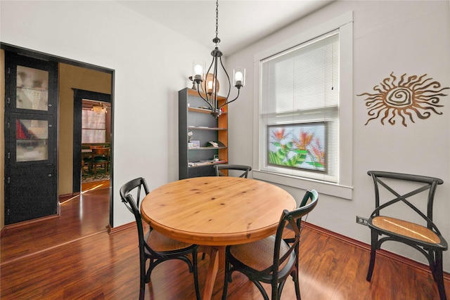 403 S Royall, Palestine, TX 75801 - dining space featuring a chandelier, dark wood-type flooring, and baseboards