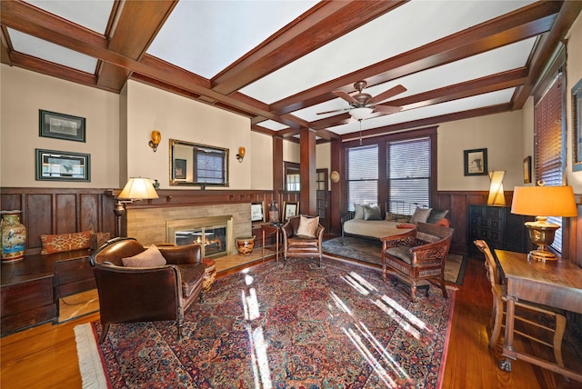 403 S Royall, Palestine, TX 75801 - living room with wainscoting, beam ceiling, a glass covered fireplace, wood finished floors, and ceiling fan