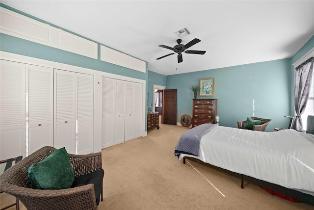 403 S Royall, Palestine, TX 75801 - bedroom featuring two closets, light carpet, multiple windows, and a ceiling fan