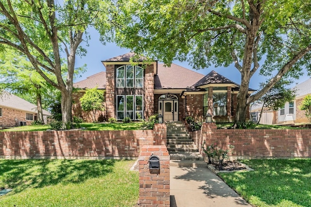 707 Kyle Dr, Arlington, TX 76011 - traditional-style home featuring a front lawn, brick siding, and roof with shingles