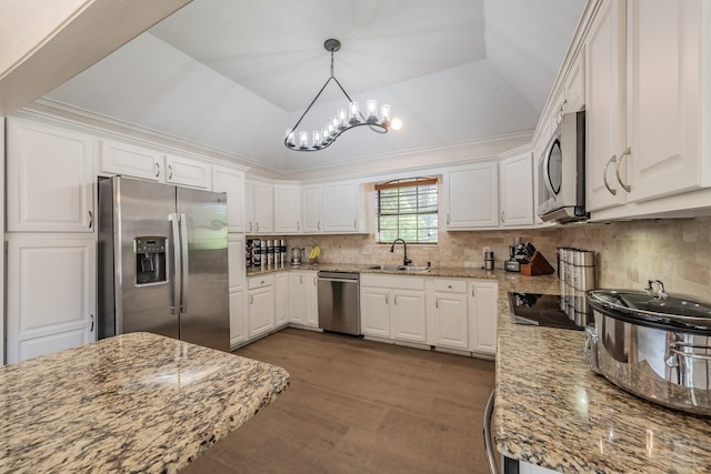 707 Kyle Dr, Arlington, TX 76011 - kitchen with appliances with stainless steel finishes, a sink, a chandelier, white cabinets, and backsplash