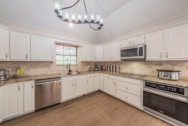 707 Kyle Dr, Arlington, TX 76011 - kitchen featuring stainless steel appliances, a sink, white cabinetry, and light wood-style flooring