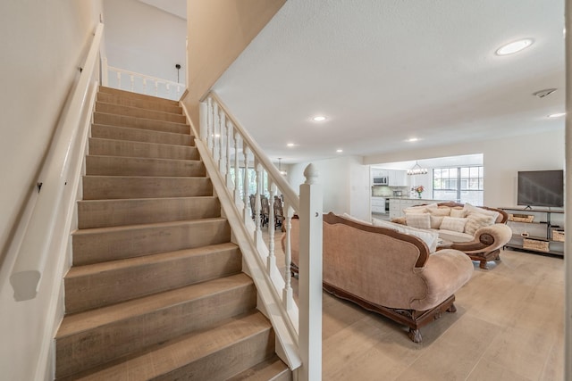 707 Kyle Dr, Arlington, TX 76011 - staircase featuring wood finished floors, recessed lighting, and a chandelier