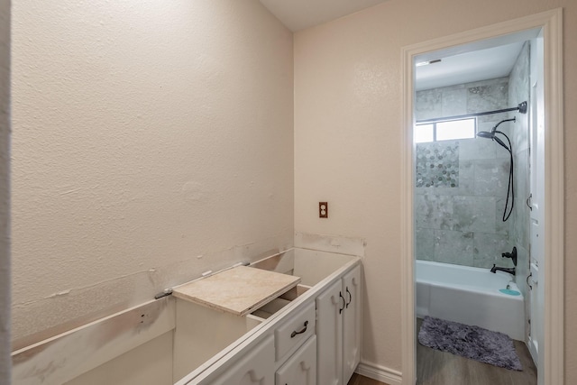 707 Kyle Dr, Arlington, TX 76011 - bathroom featuring bathtub / shower combination and wood finished floors