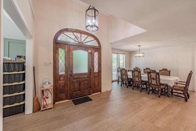 707 Kyle Dr, Arlington, TX 76011 - foyer with light wood-style flooring and a chandelier