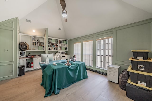 707 Kyle Dr, Arlington, TX 76011 - dining area with a decorative wall, light wood-type flooring, high vaulted ceiling, and ceiling fan