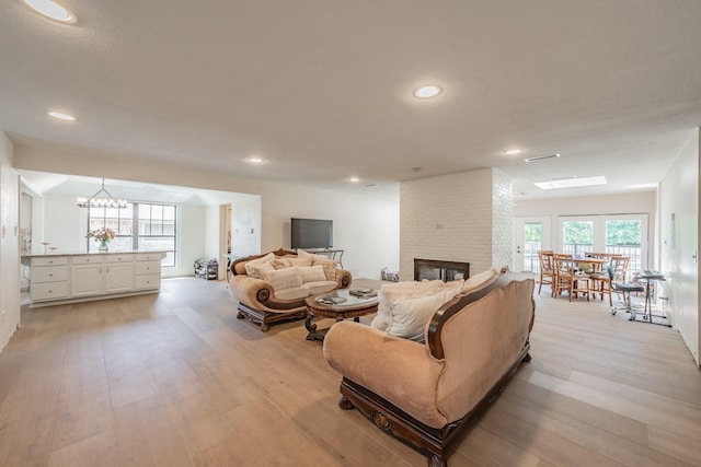 707 Kyle Dr, Arlington, TX 76011 - living room with a brick fireplace, light wood-style floors, and recessed lighting