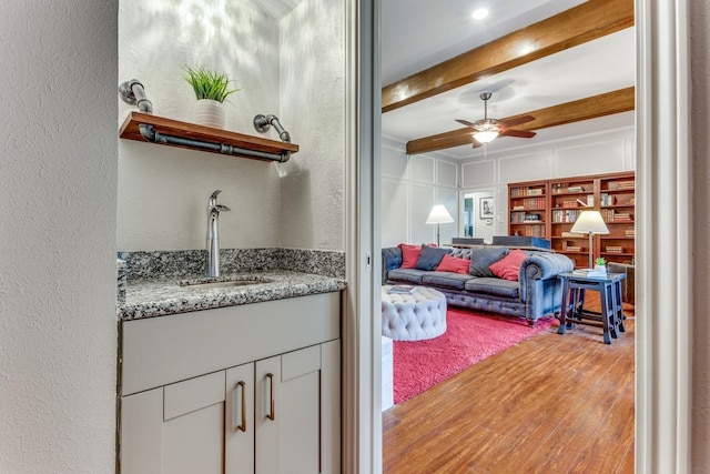 10014 Silver Creek Rd, Dallas, TX 75243 - living room featuring a textured wall, a ceiling fan, light wood-style floors, and beam ceiling
