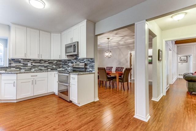 10014 Silver Creek Rd, Dallas, TX 75243 - kitchen with appliances with stainless steel finishes, tasteful backsplash, and light wood-type flooring