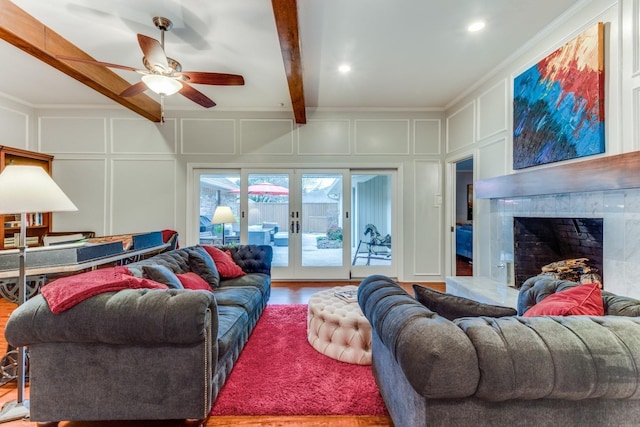 10014 Silver Creek Rd, Dallas, TX 75243 - living room featuring a decorative wall, a ceiling fan, wood finished floors, a fireplace, and beam ceiling