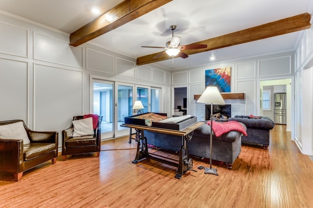 10014 Silver Creek Rd, Dallas, TX 75243 - living area featuring a decorative wall, beamed ceiling, light wood finished floors, a ceiling fan, and ornamental molding