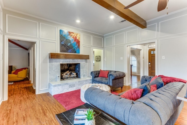 10014 Silver Creek Rd, Dallas, TX 75243 - living area with a decorative wall, ornamental molding, ceiling fan, light wood-style flooring, and a fireplace
