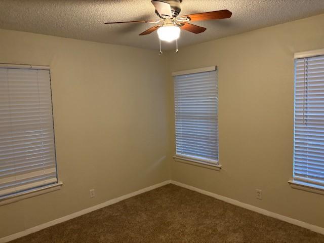 437 Browning Dr, Arlington, TX 76010 - carpeted empty room with ceiling fan, a textured ceiling, and baseboards