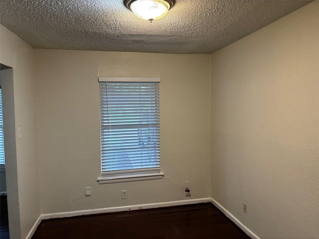437 Browning Dr, Arlington, TX 76010 - spare room featuring baseboards, dark wood-style floors, and a textured ceiling